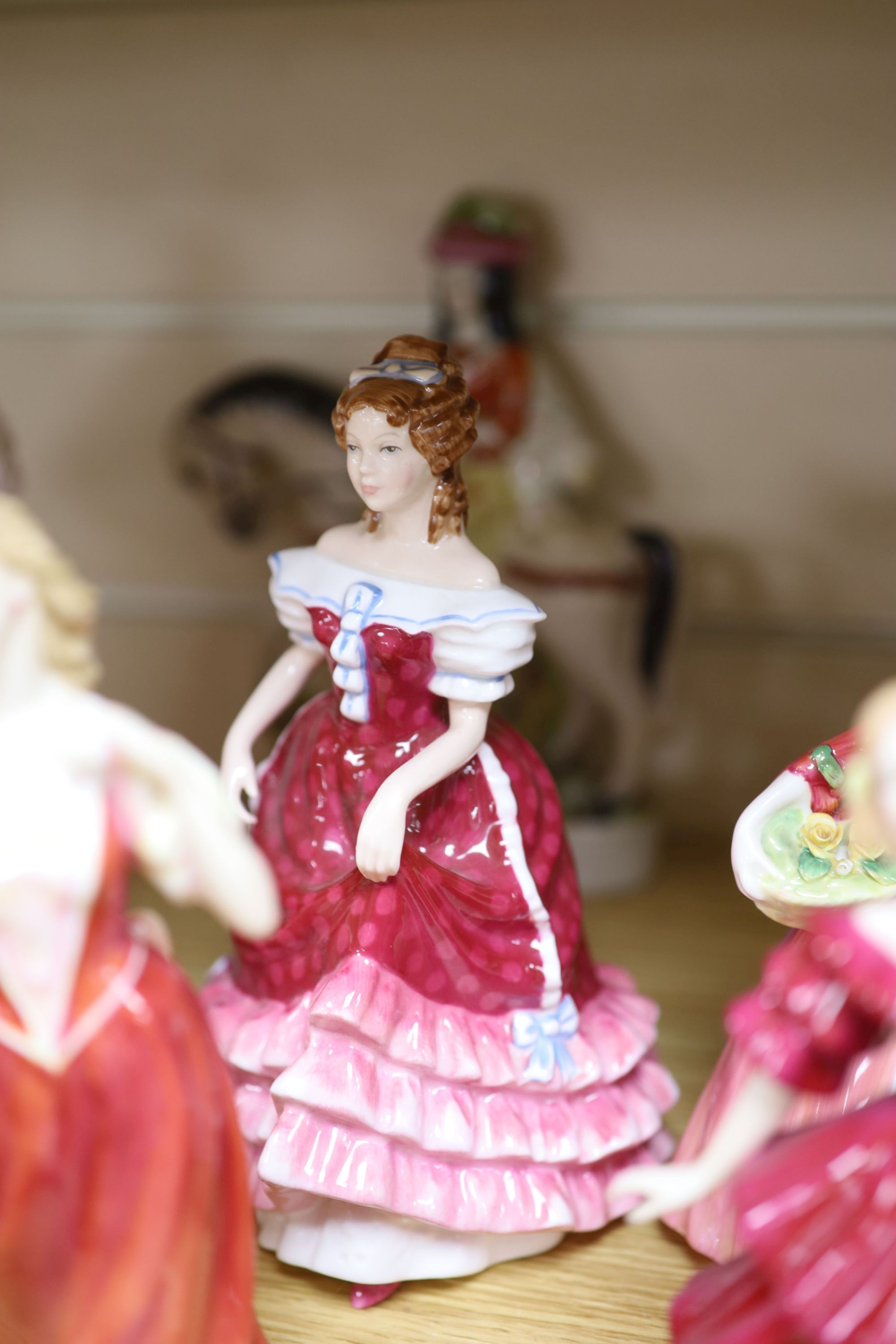 Five Royal Doulton porcelain ladies, two Coalport, one Worcester, another porcelain lady and a Staffordshire figure